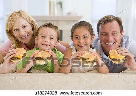 Family Eating Cheeseburgers Together View Large Photo Image Stock Photo - Family Eating Cheeseburgers Together. Fotosearch