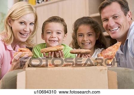 Stock Image - Family Eating Pizza Together . Fotosearch