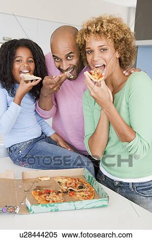 Stock Photography - Family Eating Pizza Together . Fotosearch