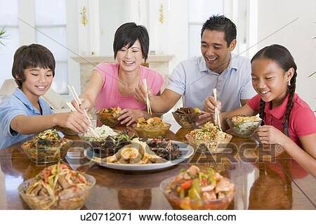 Stock Image - Family Enjoying meal, mealtime Together. Fotosearch