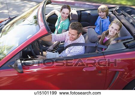 Stock Photo - Family in convertible car smiling. Fotosearch