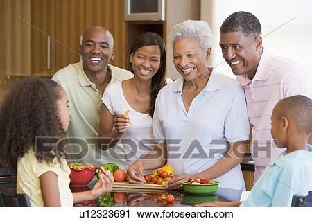 Stock Image - Family Preparing meal, mealtime Together . Fotosearch