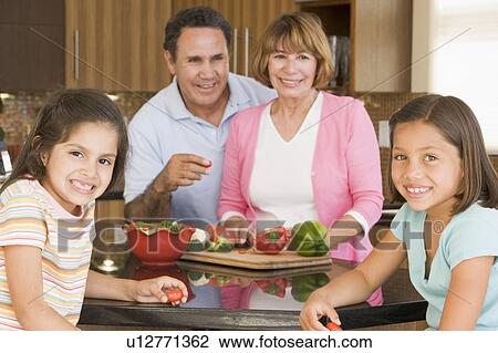Stock Image - Family Preparing meal, mealtime Together . Fotosearch