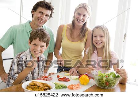 Stock Image - Family Preparing meal, mealtime Together . Fotosearch