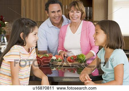 Stock Image - Family Preparing meal, mealtime Together . Fotosearch