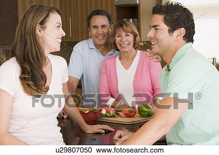 Stock Image - Family Preparing meal, mealtime Together . Fotosearch
