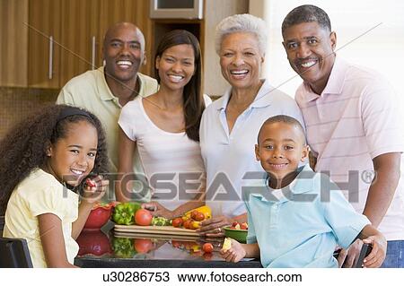 Stock Image - Family Preparing meal, mealtime Together . Fotosearch