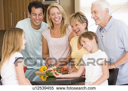 Stock Photography - Family Preparing meal, mealtime Together . Fotosearch