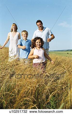 Family running outdoors smiling View Large Photo Image Stock Image - Family running outdoors smiling. Fotosearch