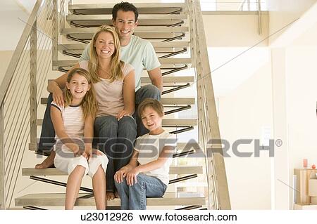 Family sitting on staircase smiling View Large Photo Image Stock Photograph - Family sitting on staircase smiling. Fotosearch