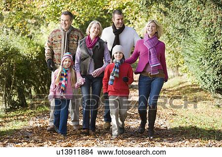 Picture - Family walking on path outdoors smiling (selective focus). Fotosearch