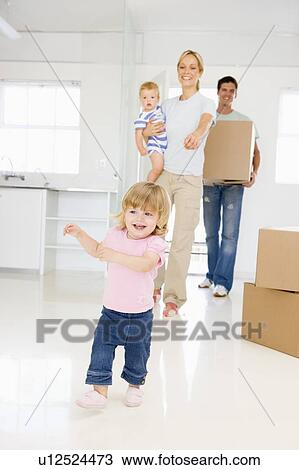 Family with box moving into new home smiling View Large Photo Image Stock Image - Family with box moving into new home smiling. Fotosearch