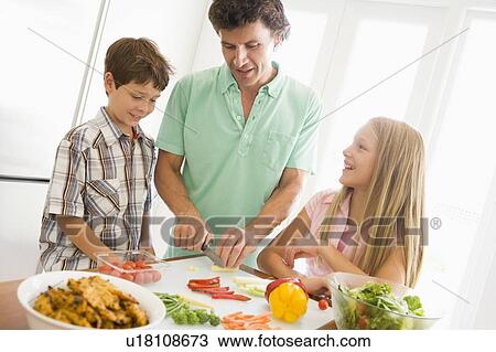 Father And Children Prepare A meal, mealtime Together View Large Photo Image Stock Image - Father And Children Prepare A meal, mealtime Together . Fotosearch