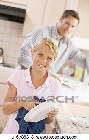 Stock Photo - Father And Daughter Cleaning Dishes. Fotosearch