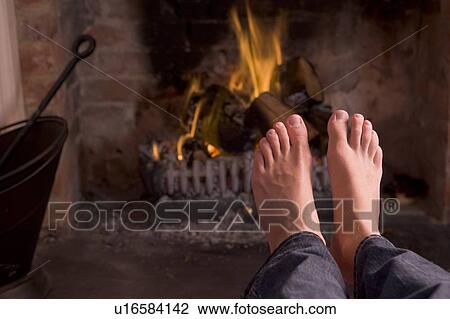 Feet warming at a fireplace View Large Photo Image Stock Image - Feet warming at a fireplace. Fotosearch