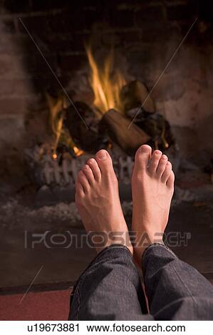 Feet warming at a fireplace View Large Photo Image Stock Image - Feet warming at a fireplace. Fotosearch