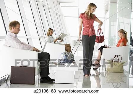 Female airline passenger waiting with other passengers in departure gate View Large Photo Image Stock Photo - Female airline passenger waiting with other passengers in departure gate. Fotosearch