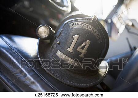 Firefighting helmet in fire engine on seat (selective focus) View Large Photo Image Stock Photography - Firefighting helmet in fire engine on seat (selective focus). Fotosearch