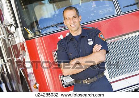 Fireman standing in front of fire engine View Large Photo Image Stock Image - Fireman standing in front of fire engine. Fotosearch