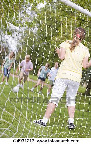 Five young friends playing soccer View Large Photo Image Stock Image - Five young friends playing soccer. Fotosearch
