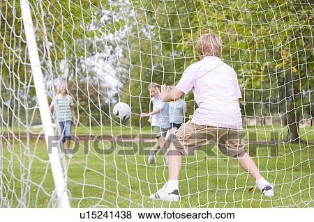 Five young friends playing soccer View Large Photo Image Stock Photo - Five young friends playing soccer. Fotosearch