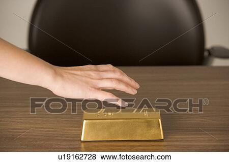 Stock Photo - Gold Bar On Desk . Fotosearch