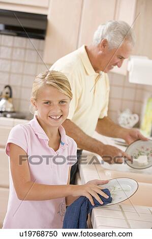 Grandfather And Granddaughter Cleaning Dishes Together View Large Photo Image Stock Image - Grandfather And Granddaughter Cleaning Dishes Together. Fotosearch