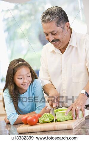 Stock Photo - Grandfather And Granddaughter Preparing meal, mealtime Together. Fotosearch