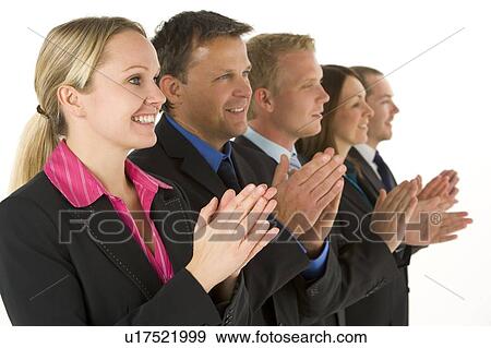 Stock Photo - Group Of Business People In A Line Smiling And Applauding. Fotosearch