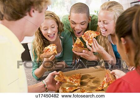 Group Of Teenagers Eating Pizza View Large Photo Image Stock Image - Group Of Teenagers Eating Pizza . Fotosearch