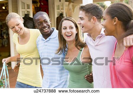 Stock Photo - Group Of Teenagers Out Shopping. Fotosearch