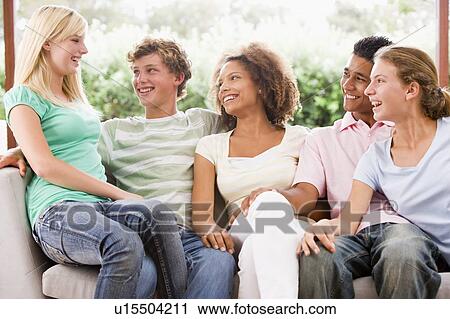 Group Of Teenagers Sitting On A Couch View Large Photo Image Stock Image - Group Of Teenagers Sitting On A Couch. Fotosearch