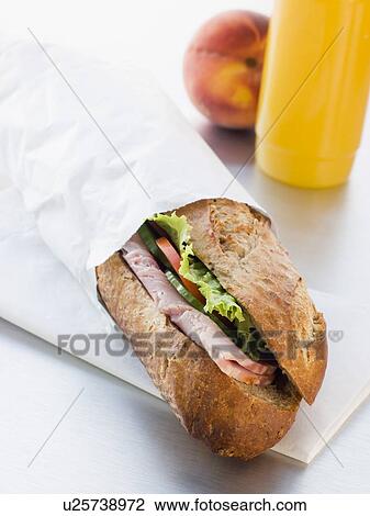 Stock Image - Ham And Salad Granary Baguette With Mango And Banana Smoothie And A Nectarine. Fotosearch