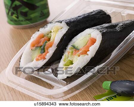 Stock Image - Hand Moulded Sushi With A Can Of Green Tea. Fotosearch