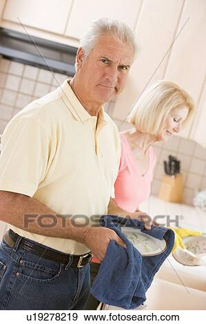 Stock Photo - Husband And Wife Cleaning Dishes. Fotosearch
