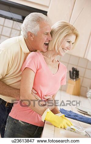 Stock Photo - Husband And Wife Cleaning Dishes. Fotosearch