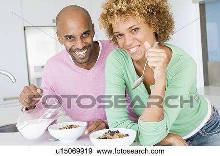 Stock Photo - Husband And Wife Eating Breakfast Together. Fotosearch