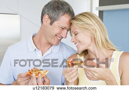 Stock Photo - Husband And Wife Eating Pizza. Fotosearch