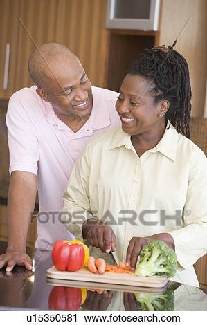Husband And Wife Preparing A meal, mealtime Together View Large Photo Image Stock Image - Husband And Wife Preparing A meal, mealtime Together. Fotosearch