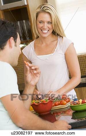 Stock Photo - Husband And Wife Preparing Dinner. Fotosearch