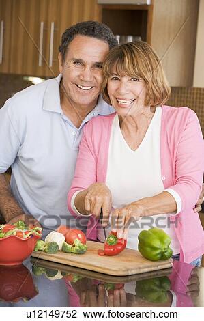 Stock Image - Husband And Wife Preparing meal, mealtime Together. Fotosearch