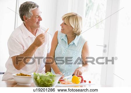 Stock Photograph - Husband And Wife Preparing meal, mealtime Together. Fotosearch