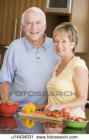 Stock Image - Husband And Wife Preparing Vegetables. Fotosearch