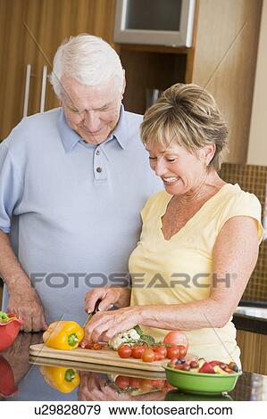 Stock Photo - Husband And Wife Preparing Vegetables. Fotosearch