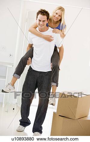 Husband giving wife piggyback in new home smiling View Large Photo Image Stock Image - Husband giving wife piggyback in new home smiling. Fotosearch