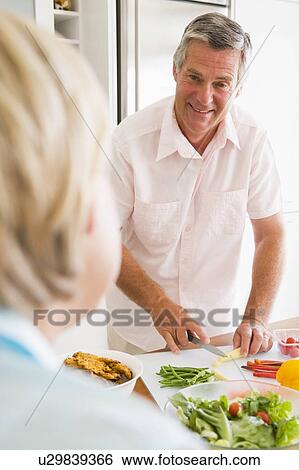 Husband Talking To Wife While Preparing meal, mealtime View Large Photo Image Stock Photograph - Husband Talking To Wife While Preparing meal, mealtime. Fotosearch