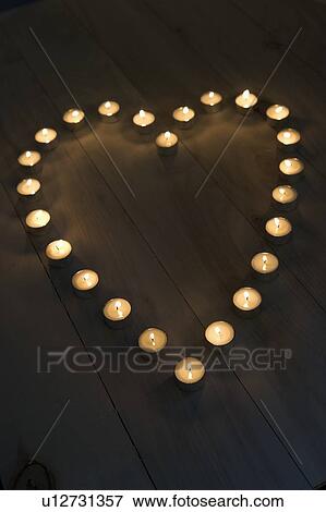 Stock Photo - Illuminated Candles Placed In A Heart Shape. Fotosearch