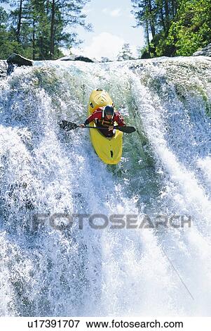 Kayaker in rapids coming over waterfall (selective focus) View Large Photo Image Stock Photo - Kayaker in rapids coming over waterfall (selective focus). Fotosearch