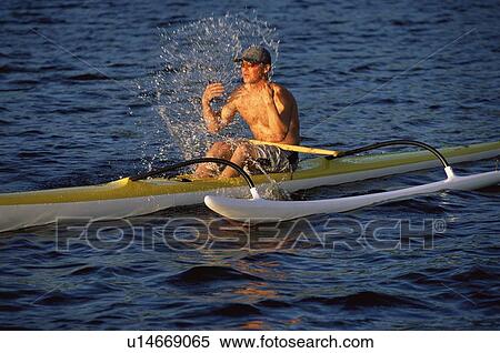 Stock Photography - Kayaker outdoors splashing water on face. Fotosearch