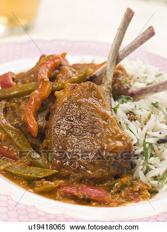 Stock Photography - Lamb Cutlet Jalfrezi with Fragrant Pilau and Indian Beer. Fotosearch